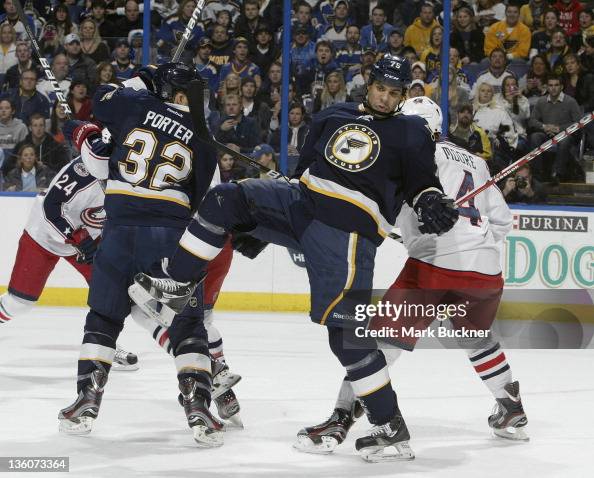 Ryan Reaves of the St. Louis Blues fights to regain his balance in an ...