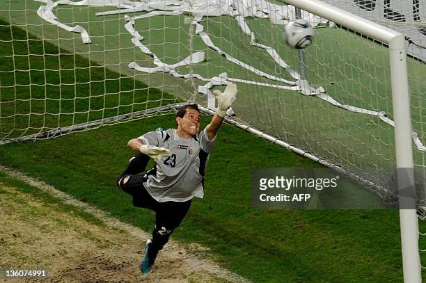Costa Rican goalkeeper Daniel Cambronero eyes the ball as it hits the crossbar during a friendly football match against Venezuela held in...