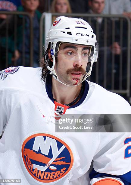 Matt Moulson of the New York Islanders bleeds from his chin during the second period in the game against the New York Rangers at Madison Square...