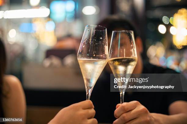 friends toasting/cheering drinks and having fun during dinner party - fun lovers unite stock pictures, royalty-free photos & images