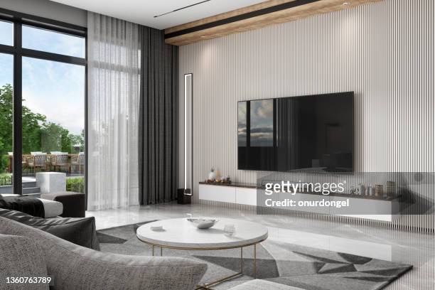 modernes wohnzimmer mit fernseher, sofa, couchtisch und blick auf den garten aus dem fenster - curtain hotel stock-fotos und bilder