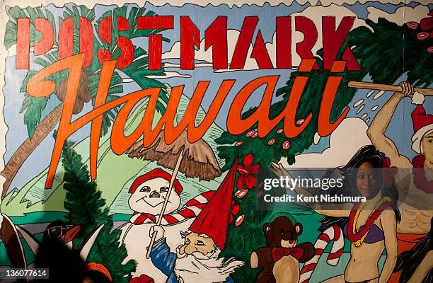 Phyllis Moore-Shelby poses for a portrait at a face cut out board at the annual Honolulu City Lights, a holiday season tradition, at the Honolulu...