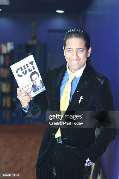 Economist and Management Guru Professor Arindam Chaudhuri poses with his new book 'The Cult" which he has co-authored with A Sandeep.