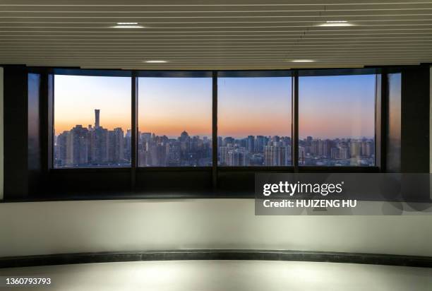 window with view of sunset city buildings. beautiful view from room window. twilight in city - windowframe stockfoto's en -beelden