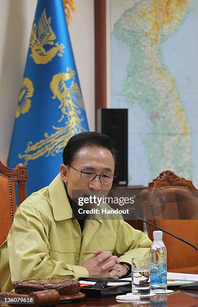 In this handout image provided by South Korean Presidential Palace, South President Lee Myung-Bak presides over an emergency Cabinet meeting at the...