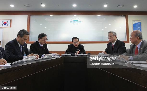 In this handout image provided by South Korean Presidential Palace, South President Lee Myung-Bak , Defense Minister Kim Kwan-Jin , Prime Minister...