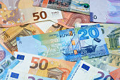 Kuwait dinars money banknote bills with European euro banknotes background