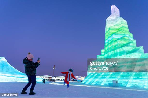 Woman poses for photos at the 23rd Harbin Ice and Snow World on the opening day on December 25, 2021 in Harbin, Heilongjiang Province of China.