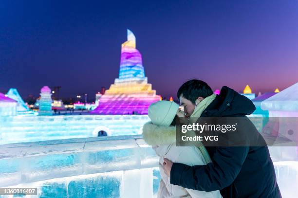 Couple kisses at the 23rd Harbin Ice and Snow World on the opening day on December 25, 2021 in Harbin, Heilongjiang Province of China.