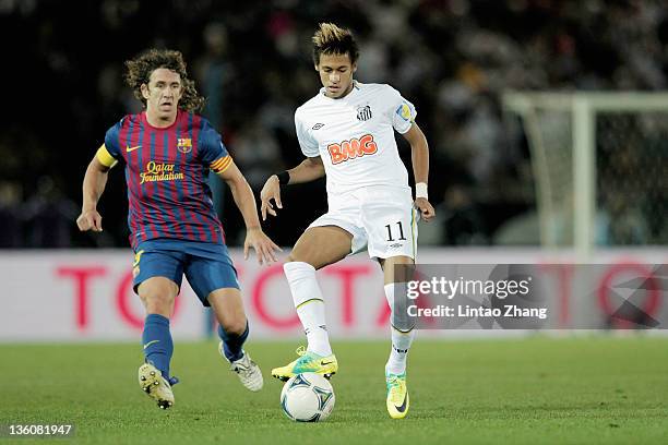 Neymar of Santos challenged by Carles Puyol of FC Barcelona during the FIFA Club World Cup Final match between Santosl and Barcelona at the Yokohama...