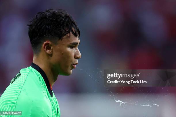 Ikhsan Fandi of Singapore spits as he takes over as goalkeeper following a red card issued to goalkeeper Hassan Sunny during extra time in the second...