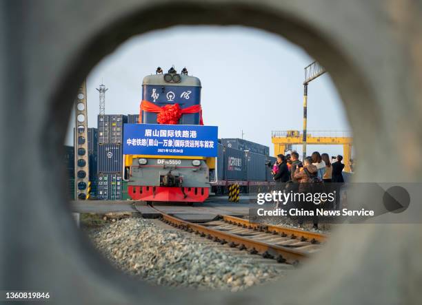 Freight train carrying containers departs for Vientiane following the opening of the China-Laos Railway on December 24, 2021 in Meishan, Sichuan...