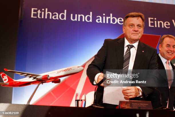 Hartmut Mehdorn, CEO of German airline Airberlin and James Hogan, CEO of Etihad Airways gesture during a press conference on December 19, 2011 in...