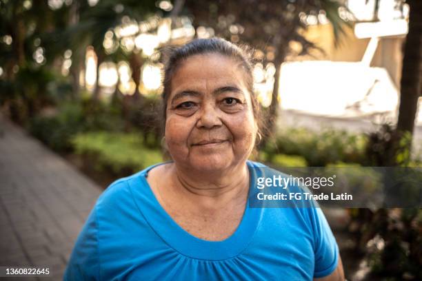 portrait of a senior woman outdoors - mexican woman stock pictures, royalty-free photos & images