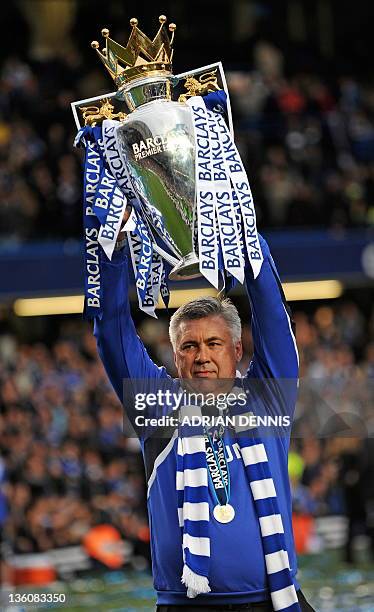 Chelsea's Italian manager Carlo Ancelotti celebrates with the Barclays Premier League trophy after Chelsea win the title with a 8-0 victory over...