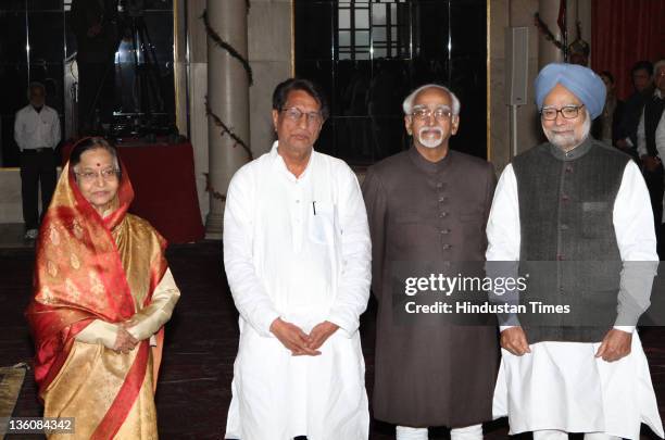 President Pratibha Devi Singh Patil, Vice-President Hamid Ansari, Prime Minister Manmohan Singh with new Cabinet Minister Ajit Singh after his...