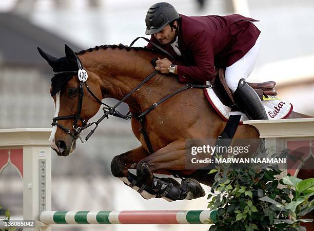 Qatar's Ali al-Rumaihi competes with Ravenna 323 in the individual jumping equestrian final at the 2011 Arab Games in the Qatari capital Doha on...