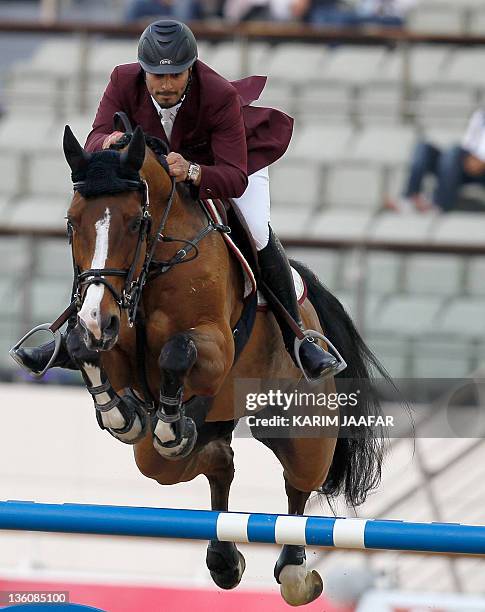 Qatar's Ali al-Rumaihi competes with Ravenna 323 in the individual jumping equestrian final at the 2011 Arab Games in the Qatari capital Doha on...