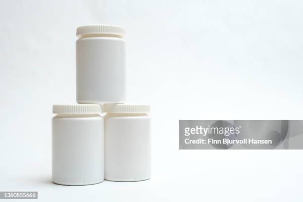 three neutral white pill boxes stacked on top of each other. isolated against white - finn bjurvoll imagens e fotografias de stock