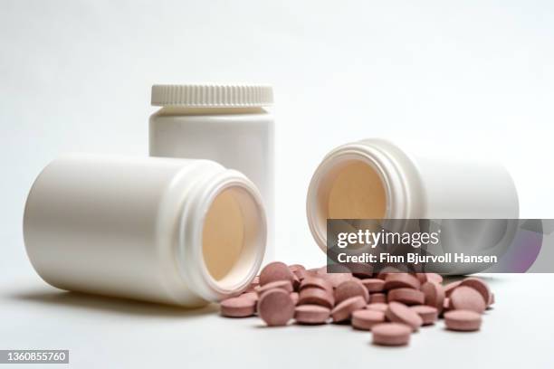 three neutral white pill boxes. two lying open with pills on the outside isolated against white background. - finn bjurvoll imagens e fotografias de stock