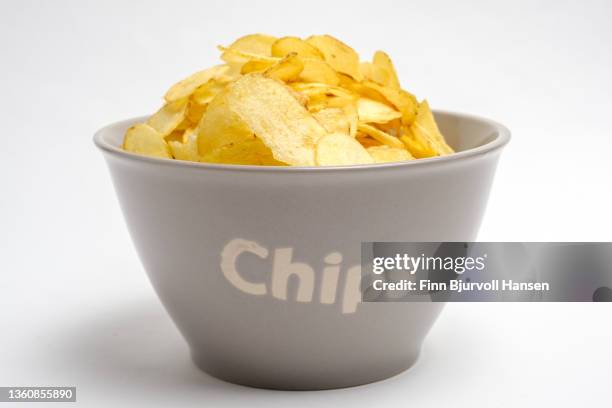 gray bowl with potato chips. isolated against a white background - finn bjurvoll imagens e fotografias de stock