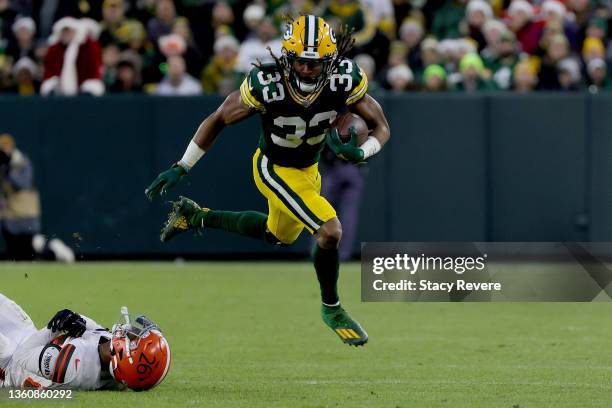 Aaron Jones of the Green Bay Packers breaks a tackle attempt by Greedy Williams of the Cleveland Browns in the second quarter at Lambeau Field on...