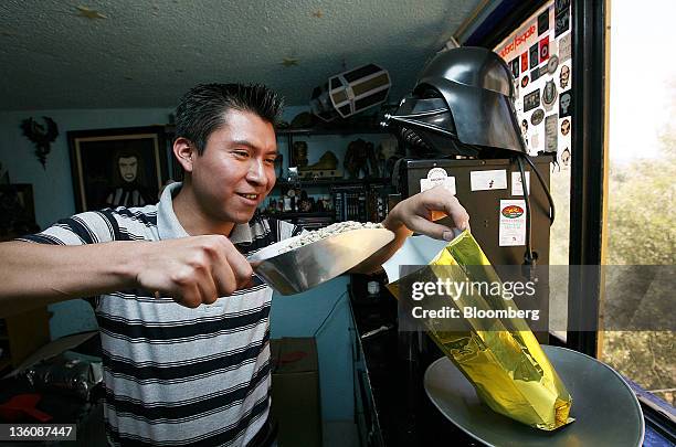 Juan Carlos Lopez, an adviser to the Cafe Guerrero Maya cooperative, weighs a bag of green coffee for a photograph before roasting it in Mexico City,...
