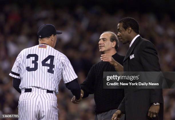 Frank Tepedino who was a Yankee outfielder (1967-1972] and fireman for 20 years shakes hands with Mel Stottlemyre after throwing out first pitch...