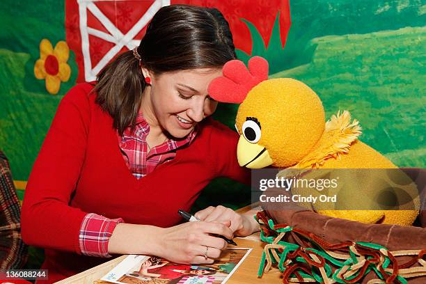 Kelly & Chica the Chicken from Sprout's "The Sunny Side Up Show" visit the NBC Experience Store on December 19, 2011 in New York City.