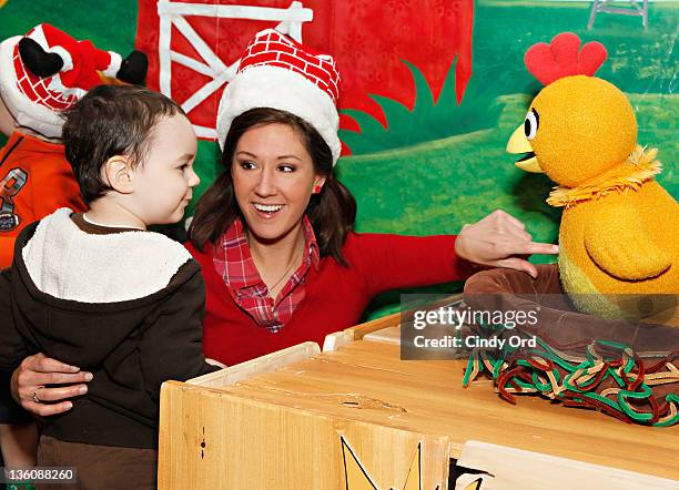 Kelly & Chica the Chicken from Sprout's "The Sunny Side Up Show" visit the NBC Experience Store on December 19, 2011 in New York City.