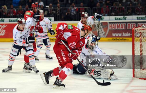 Alexander Weiss of Koeln is challenged by goalkeeper Robert Zepp of Berlin during the DEL match between Koelner Haie and Eisbaeren Berlin at Lanxess...