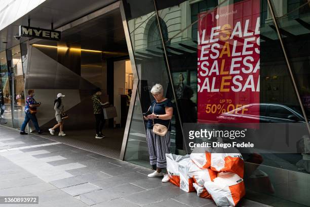Woman stands outside MYER at Little Bourke Street during the Boxing Day sales on December 26, 2021 in Melbourne, Australia. Australians celebrate...