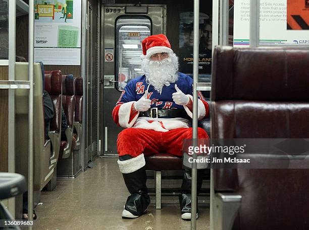 New York Ranger fan Glen Jacobson from Holbrook, New York rides the Long Island railroad dressed as Santa Claus to the game against the Philadelphia...