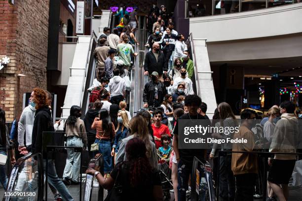 Shoppers ride an escalator at Melbourne Central during the Boxing Day sales on December 26, 2021 in Melbourne, Australia. Australians celebrate...