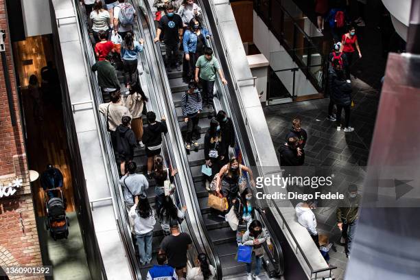 Shoppers ride an escalator at Melbourne Central during the Boxing Day sales on December 26, 2021 in Melbourne, Australia. Australians celebrate...