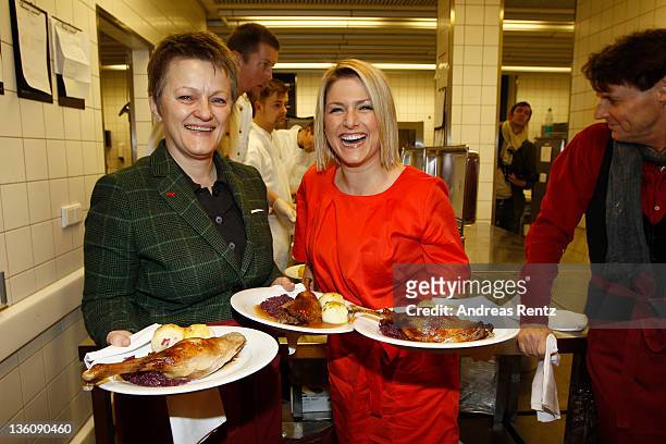 Renate Kuenast of the German Greens Party and singer Jeanette Biedermann serves Christmas goose dinner to homeless and poor people at the 17th annual...