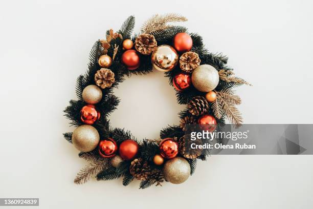 xmas wreath with pine cones, red and gold colored toys. - christmas wreath stock-fotos und bilder