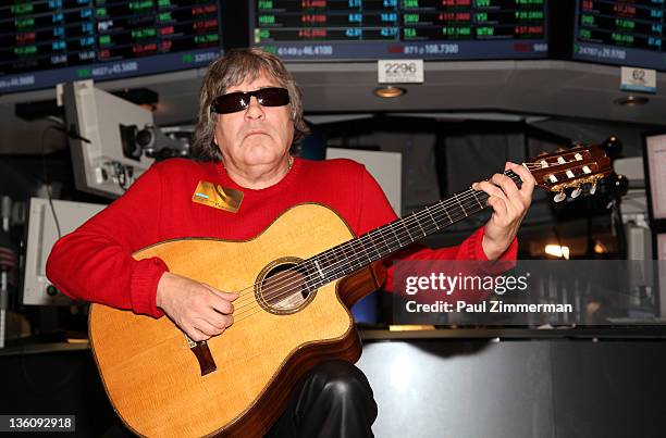 Musician Jose Feliciano plays his guitar after ringing the closing bell at the New York Stock Exchange on December 23, 2011 in New York City.