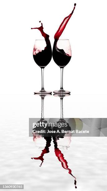 toast with two glasses of wine on a white background reflected on a water surface - glass half full party stock pictures, royalty-free photos & images