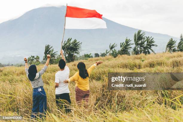young asian adults celebrate indonesia independence day - indonesia flag stock pictures, royalty-free photos & images