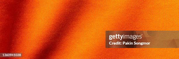orange color fabric cloth polyester texture and textile background, wide banner - jersey fabric stockfoto's en -beelden