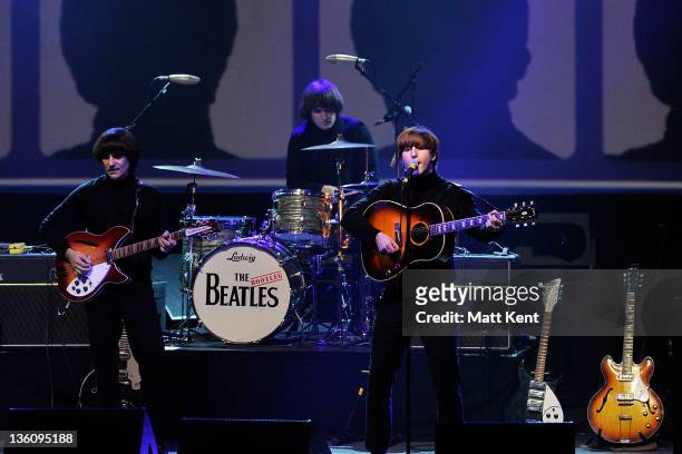 Andre Barreau , Hugo Degenhardt and Adam Hastings of The Bootleg Beatles perform on stage at HMV Hammersmith Apollo on December 19, 2011 in London,...