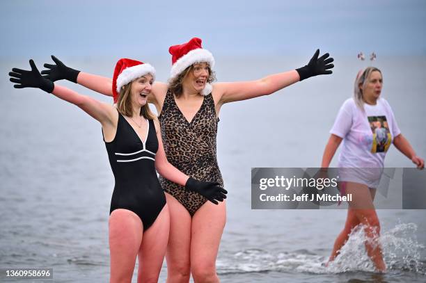 Swimmers take part in a charity Boxing Day swim at Ayr beach for Ayrshire Cancer Support on December 26, 2021 in Ayr, Scotland. New restrictions are...