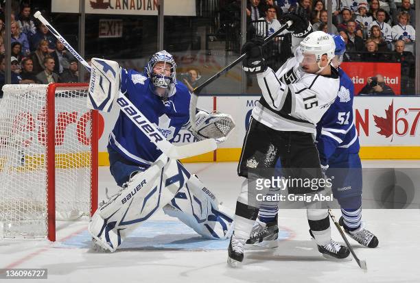 James Reimer of the Toronto Maple Leafs makes a blocker save as teammate Jake Gardiner battles with Brad Richardson of the Los Angeles Kings during...