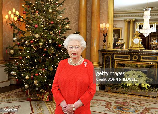 Queen Elizabeth II stands in the 1844 Room of Buckingham Palace in London after recording her Christmas Day television broadcast to the Commonwealth...