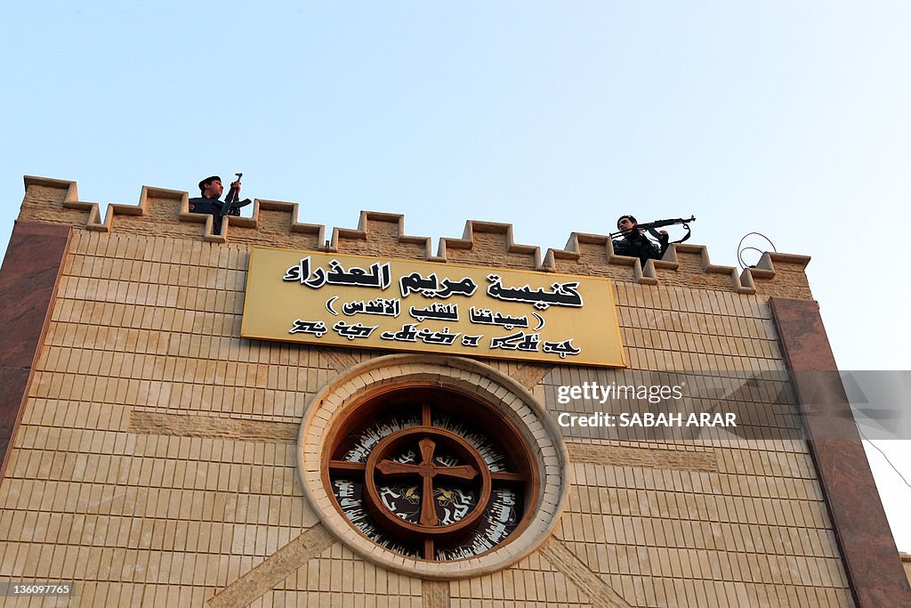 Iraqi security officers stand guard on t