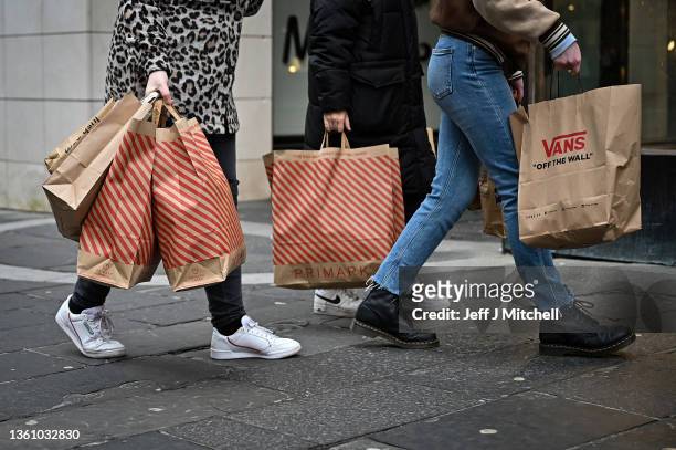 Members of the public are seen shopping during the Boxing Day sales on December 26, 2021 in Glasgow, Scotland. New restrictions are being introduced...