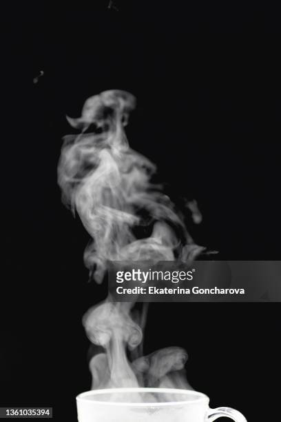 beautiful white abstract steam from tea or coffee on a black isolated background - smoke black background ストックフォトと画像