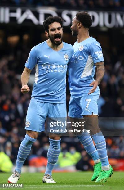 Ilkay Guendogan of Manchester City celebrates after scoring their side's third goal with Raheem Sterling during the Premier League match between...