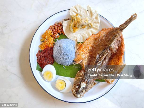 peranakan fried fish blue pea rice platter - peranakan culture stock pictures, royalty-free photos & images